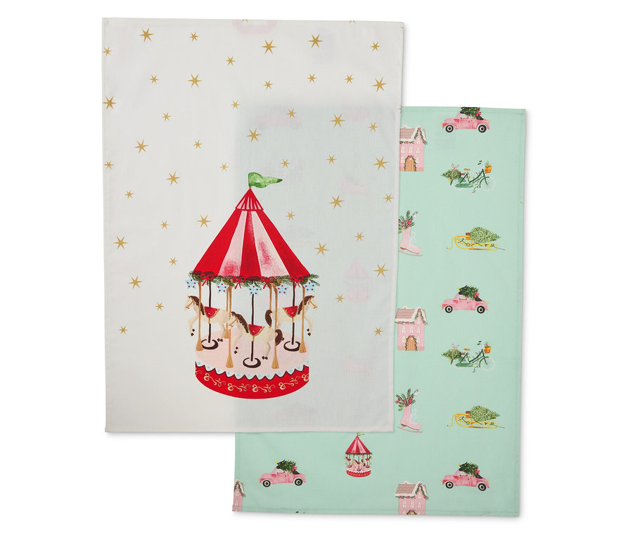 Zwei Stoffgeschirrtücher: eines mit Karussell, das andere mit Wintermotiven.