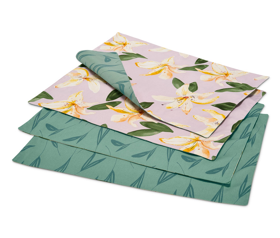 Ein Set aus 4 Wende-Platzsets, eines davon mit Blumenmuster auf lila Hintergrund und eines mit grünem Blattmuster.