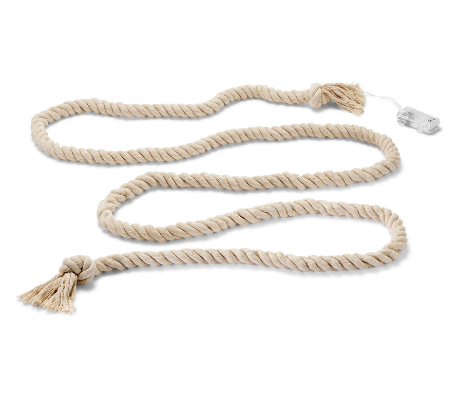 Eine LED-Lichterkette »Tau« ist in Schlaufen auf einem weißen Hintergrund gelegt.