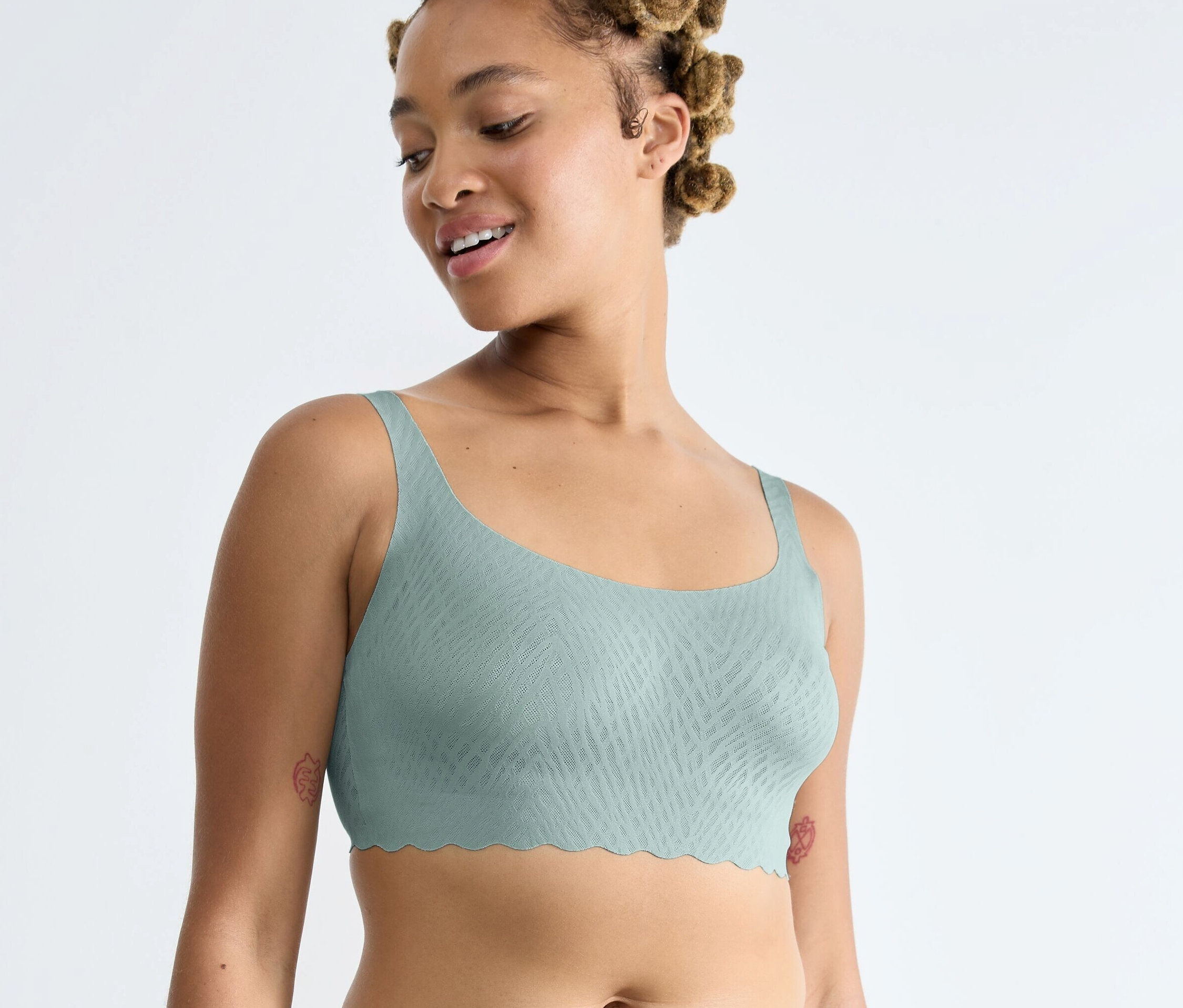 Frau trägt ein Sloggi ZERO Feel Bliss Top in Misty Turquoise.