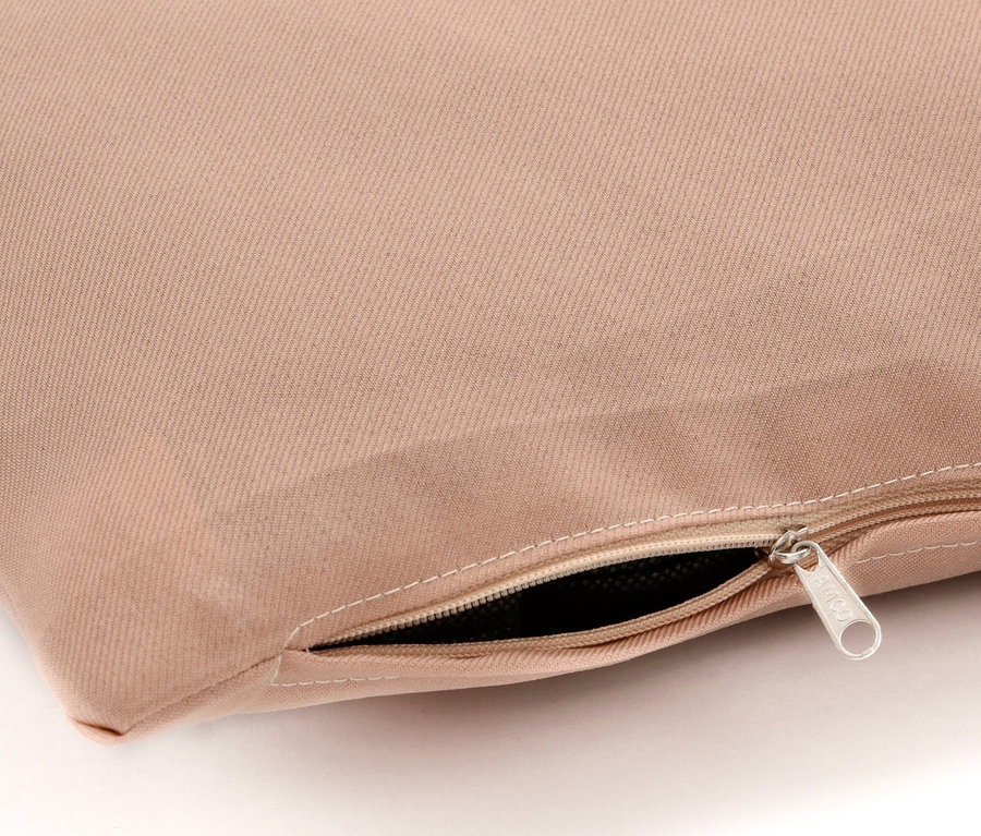Detailaufnahme eines beigen Kissens mit Reißverschluss.