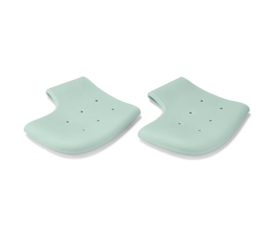 Zwei hellgrüne Fersenschutzhauben liegen auf einem weißen Hintergrund.