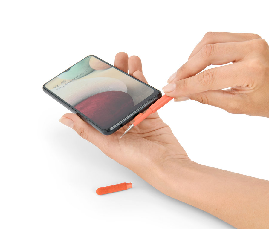 Frau reinigt ein Telefon mit einem 4-in-1-Schreibtisch-Reinigungs-Set.