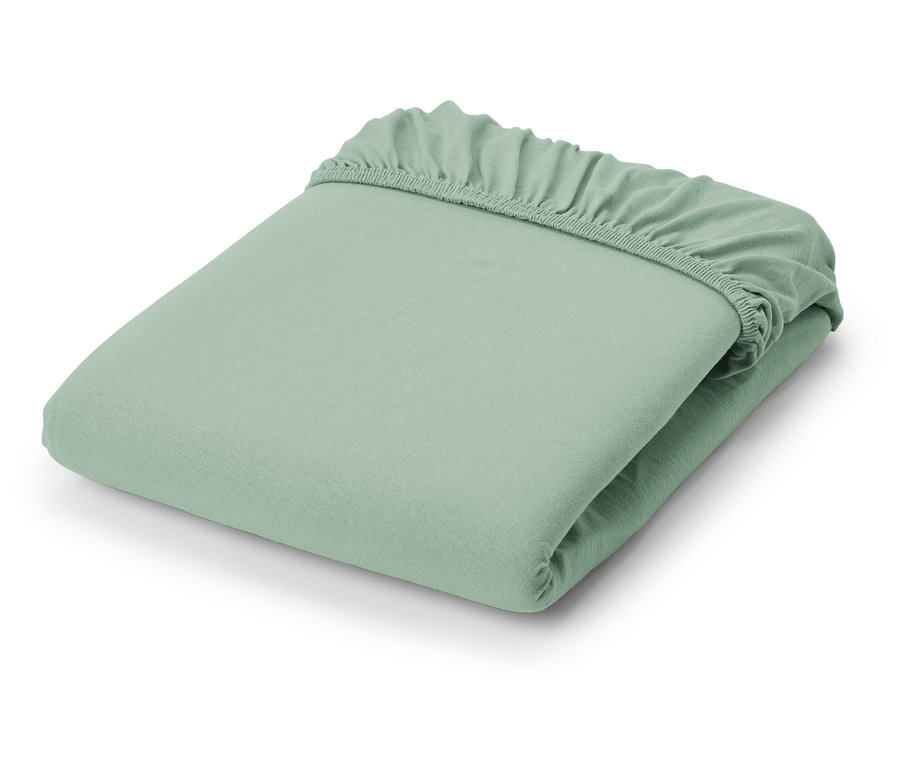 Ein gefaltetes hellgrünes Jersey-Spannbettlaken.