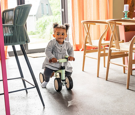 Kleines Mädchen fährt drinnen auf einem PUKY Laufrad PUKYLINO BUNDLE.