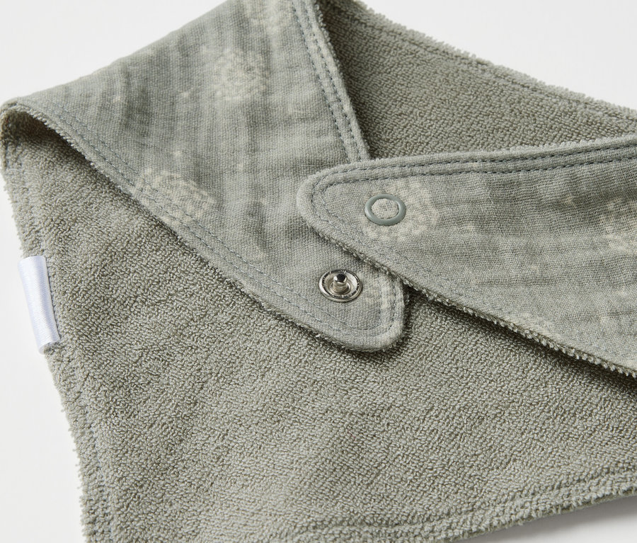 Detailaufnahme eines Baby-Musselin-Halstuchs mit Druckknöpfen.