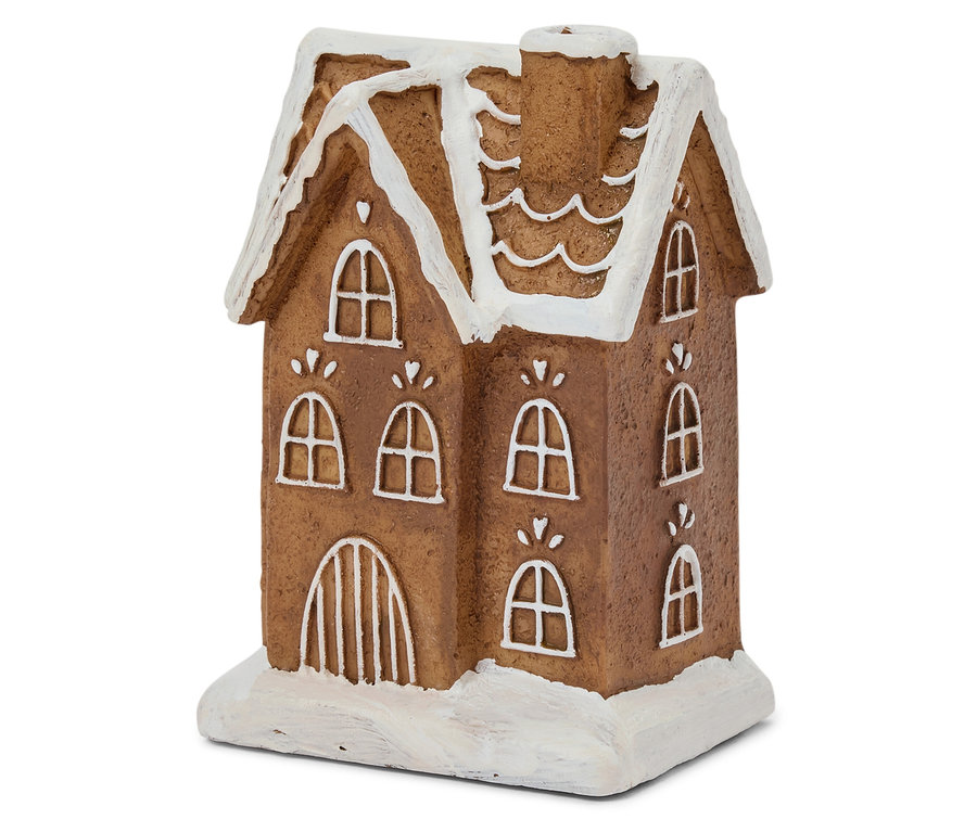 Detailaufnahme eines braunen Lebkuchenhauses mit weißer Zuckergussglasur auf Fenster und Dach.