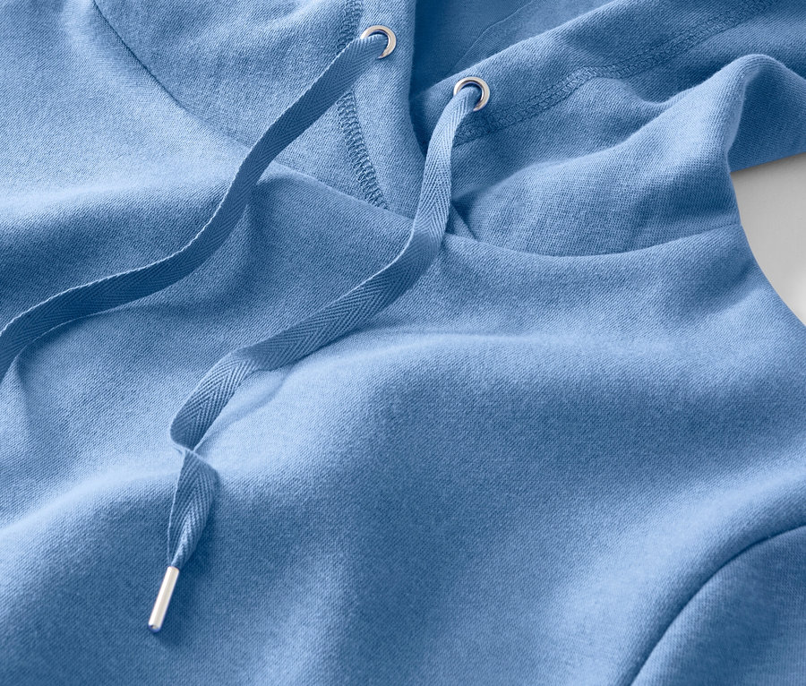 Detailansicht eines hellblauen Kapuzenpullovers mit Kordelzug.