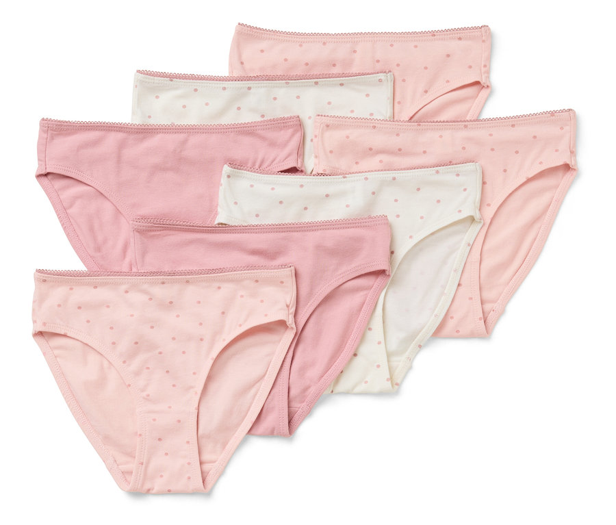 Ein Set aus sieben Damenslips in verschiedenen Rosa- und Weißtönen mit Punkten, die übereinander gestapelt sind.