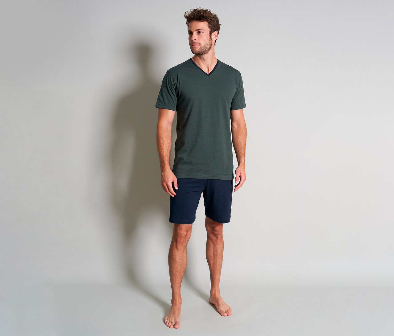 Mann steht barfuß in grünem Tom Tailor Shorty-Pyjama-Set »Nevada«.