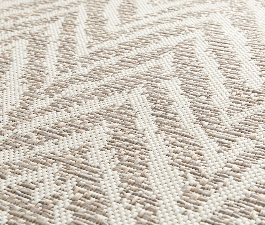 Detailaufnahme eines Outdoor-Teppichs »Ecru Flow« mit Zickzackmuster.