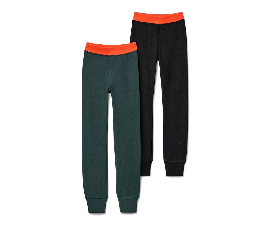Zwei lange Kinder-Winterunterhosen: eine dunkelgrün, eine schwarz, beide mit orangefarbenem Bund.