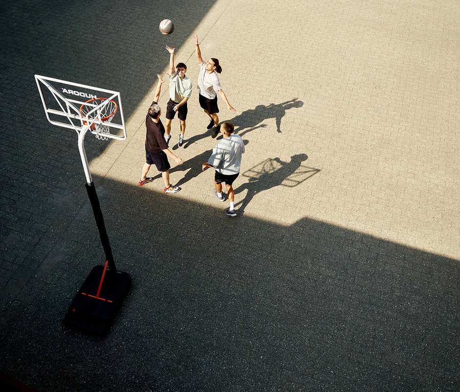 Draufsicht: Vier Personen spielen Basketball neben einem Hudora Basketballständer »RoCo« mit einer Korbhöhe von 206 cm.