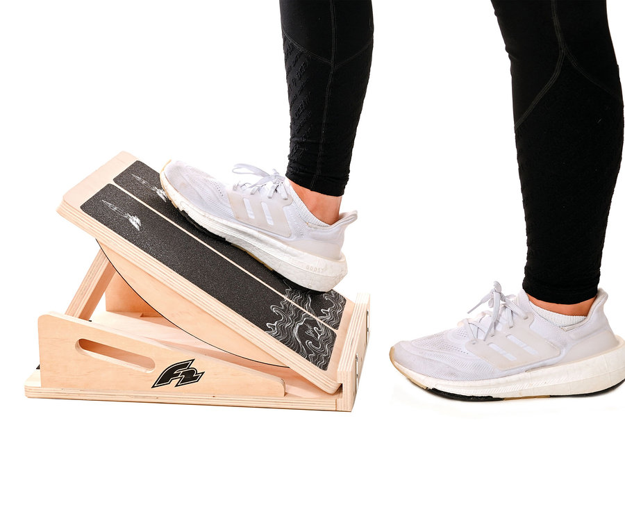 Eine Person steht mit einem Fuß auf einem F2 Step on Balance Board.
