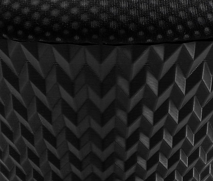 Detailaufnahme eines schwarzen Stoffes mit geometrischem Muster.