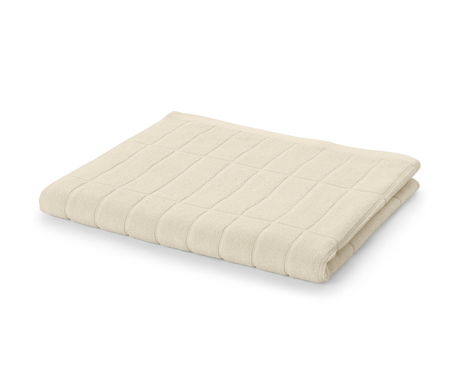 Ein cremeweißes Badetuch in Premiumqualität, gefaltet auf einem weißen Hintergrund.