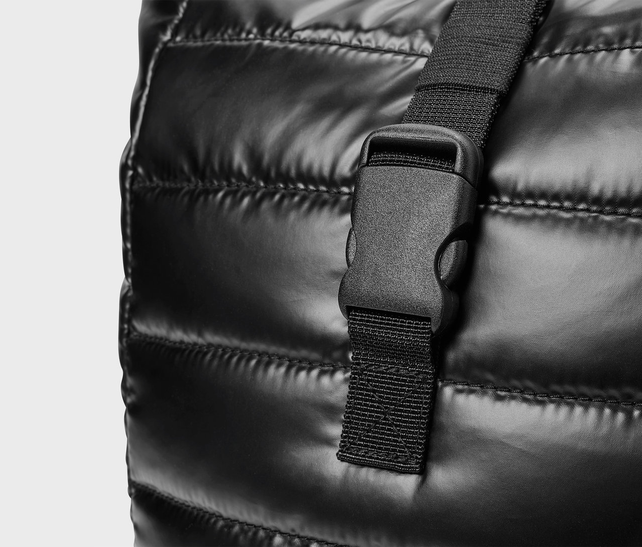 Detailaufnahme einer schwarzen Stepptasche mit Kunststoffschnalle.