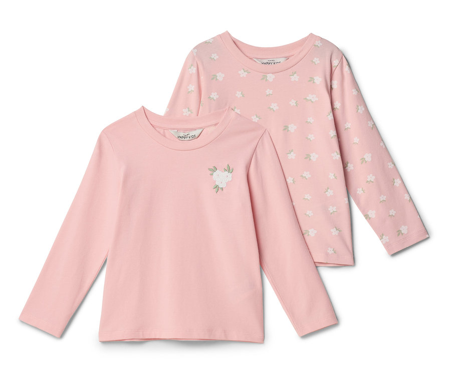 Zwei rosa Langarmshirts liegen übereinander. Das vordere Shirt ist einfarbig rosa mit einer weißen Blumenapplikation. Das hintere Shirt hat ein florales Muster.