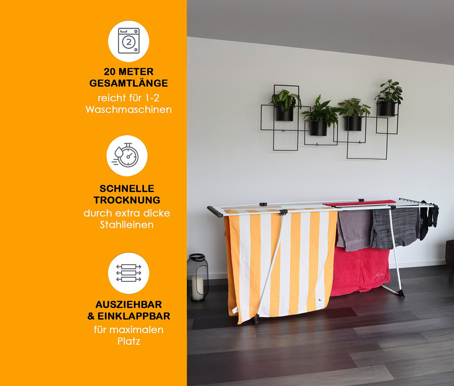 Weißer Yoursol Teleskop-Wäscheständer mit Handtüchern und Kleidung.