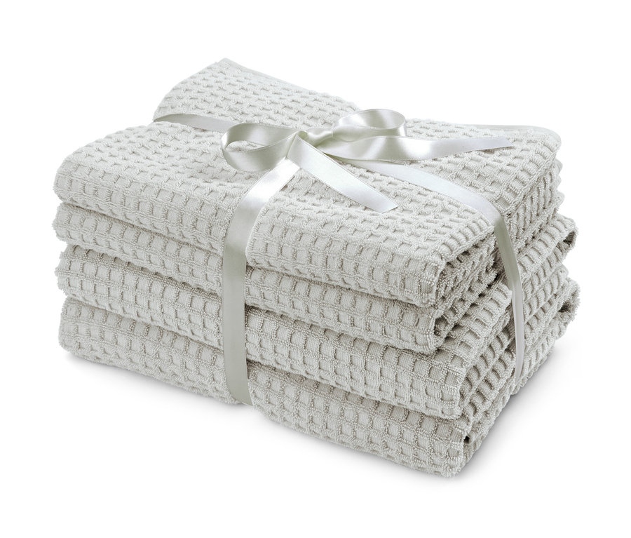 Ein Stapel hellgrauer Premium Bade- und Handtücher im Set, mit einer Schleife gebunden.