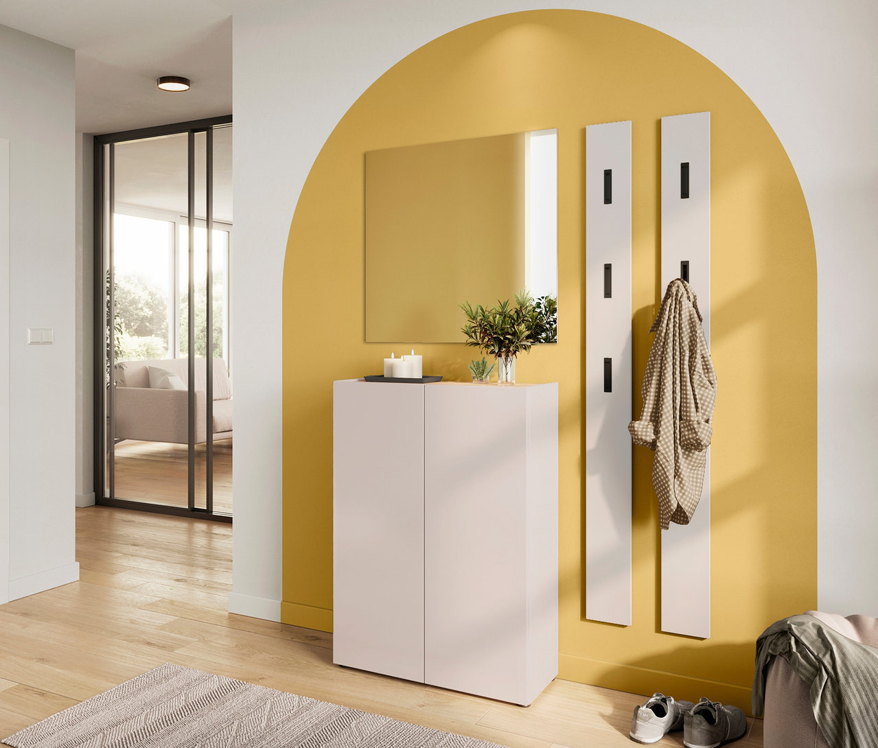 Rechteckiger Spiegel »Alviano« hängt über einem hellrosa Schuhschrank vor einer gelben Wand. Eine Jacke hängt an einer weißen Wandgarderobe.