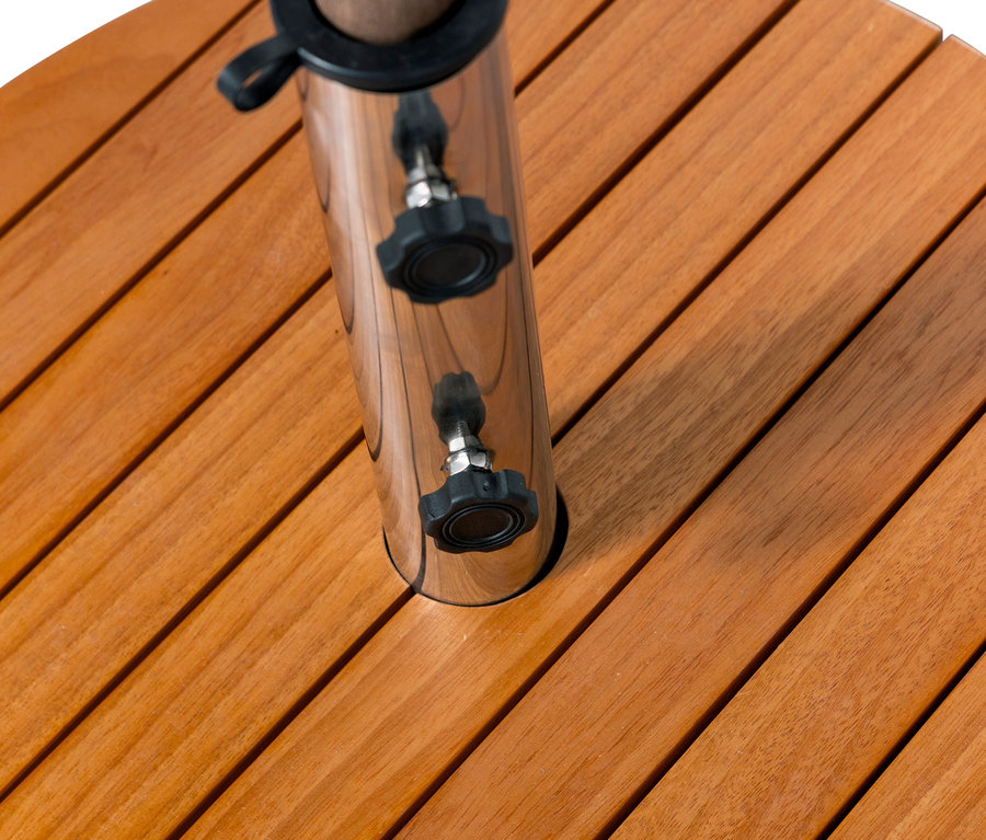 Detailansicht einer runden Holzplatte mit einer glänzenden Metallstange und zwei schwarzen Drehknöpfen.