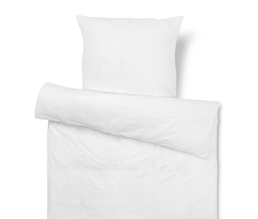 Weißer Kissen- und Bettbezug mit Textur.