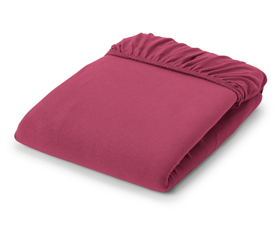 Zusammengelegtes Jersey-Spannbettlaken in Beere.