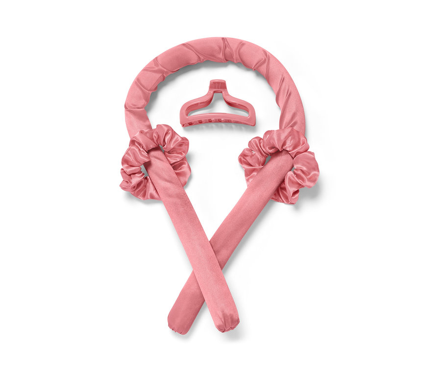 Rosa hitzefreie Lockenwickler und Haarspange auf weißem Hintergrund.