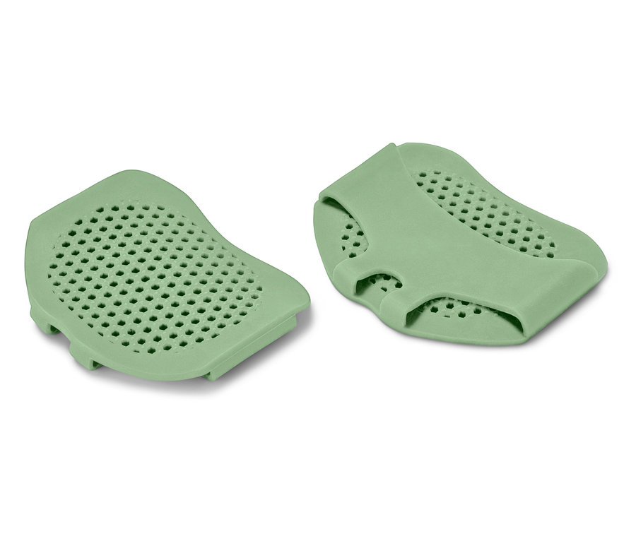 Zwei grüne Silikonpolster mit perforierter Oberfläche.