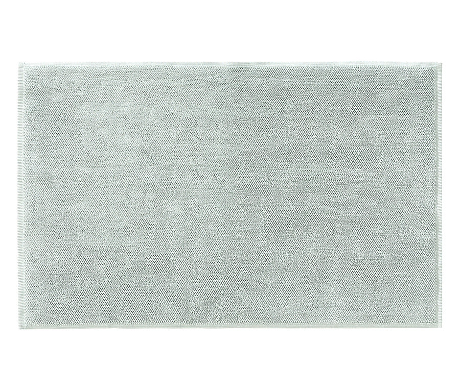 Ein rechteckiger, hellgrüner Badteppich mit einer dezenten Punktmusterung.