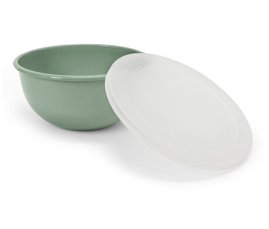 Eine grüne Schüssel mit einem weißen Deckel, der daneben liegt.