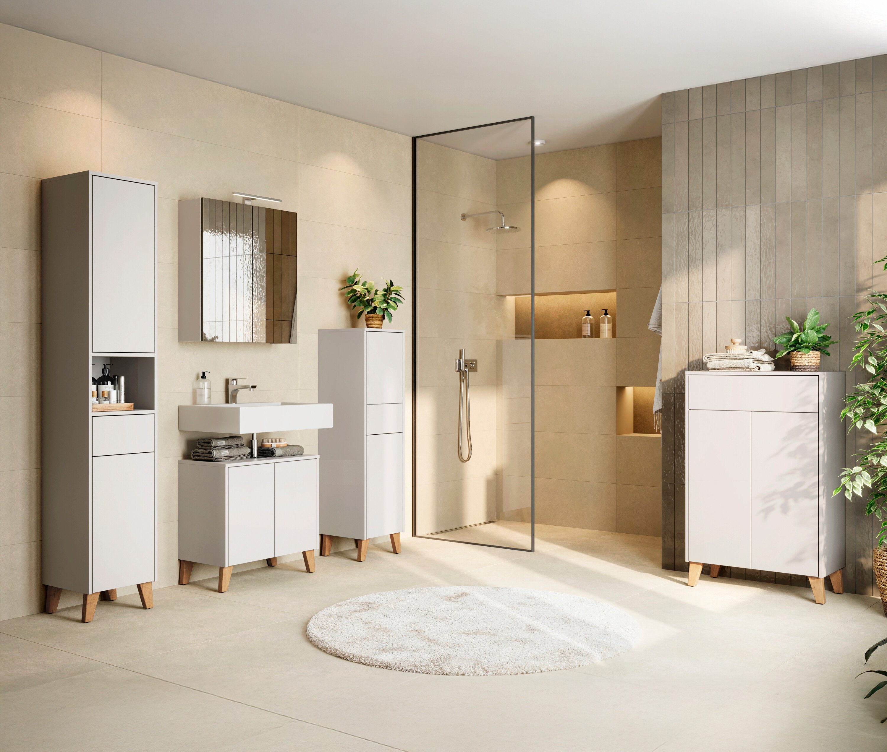 Badezimmer mit weißem Waschtisch, Spiegelschrank, Hochschrank und Dusche.