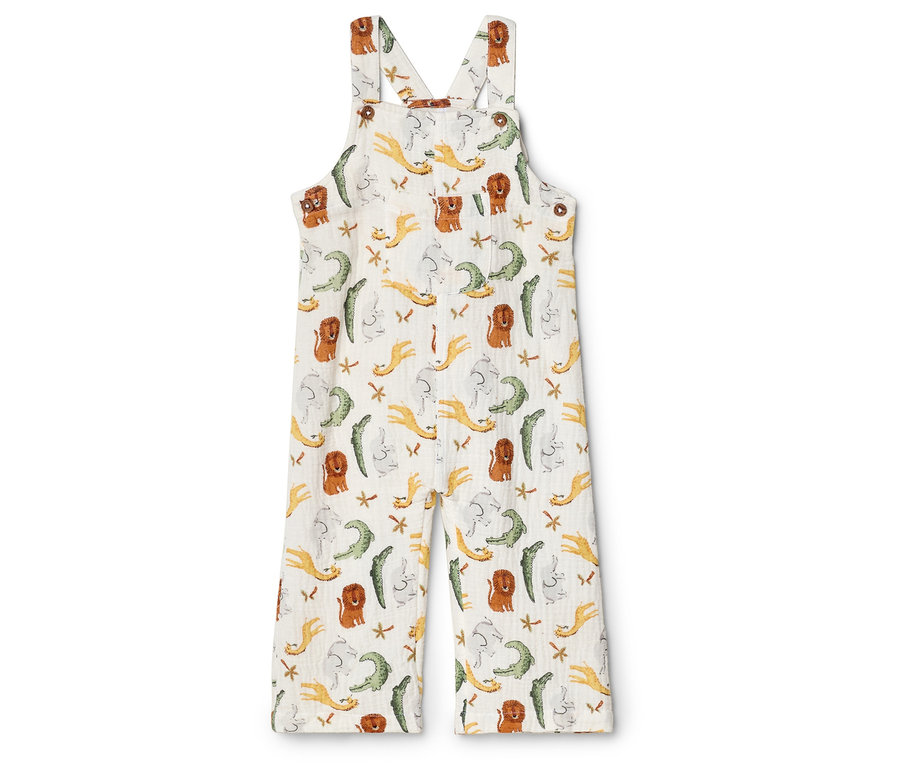 Weiße Latzhose mit Krokodil-, Löwen- und Sternenmuster.