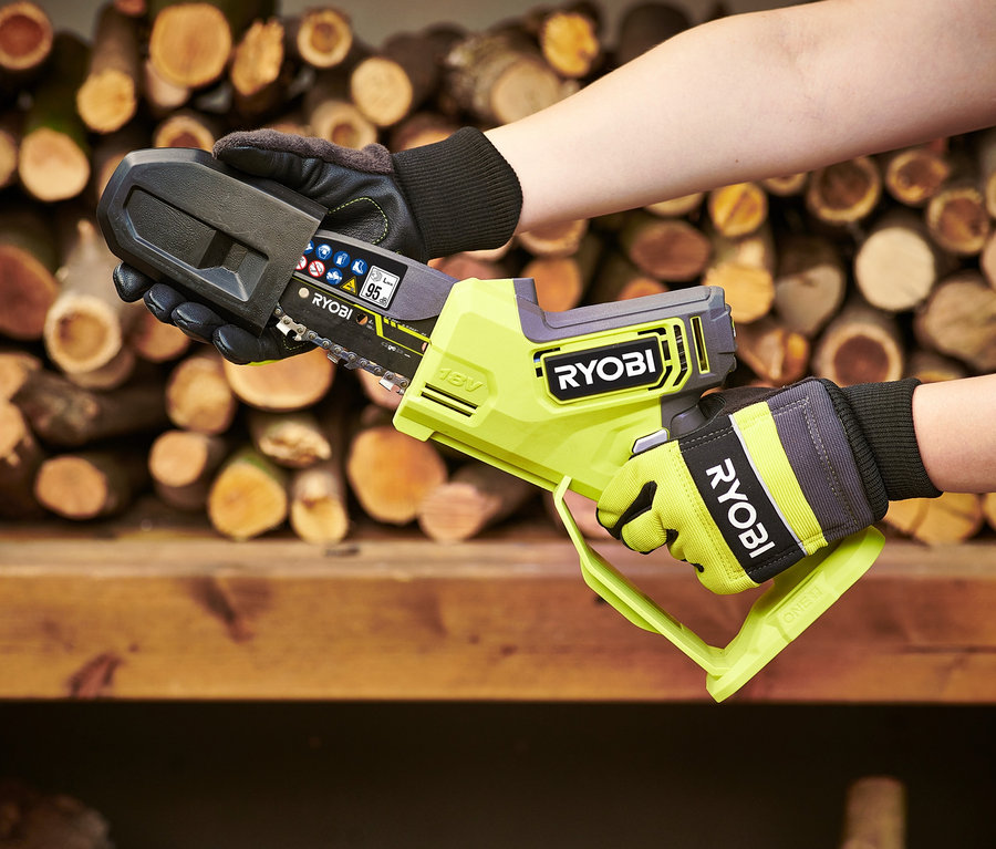 Eine Person hält eine RYOBI 18 V One+ Brushless Akku-Einhand-Kettensäge.