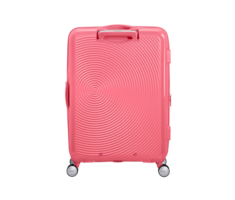 Ein mittelgrosser, sonnengeküsster, korallfarbener American Tourister Hartschalenkoffer »Soundbox« Spinner.