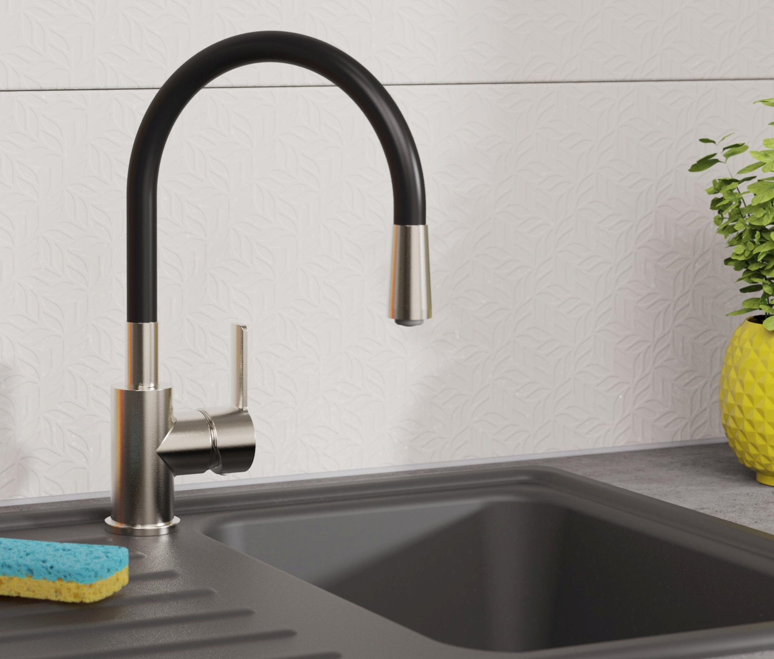 Schwarzes Spülbecken mit Edelstahl-Spültischarmatur »FLEXO« und gelber Pflanze.