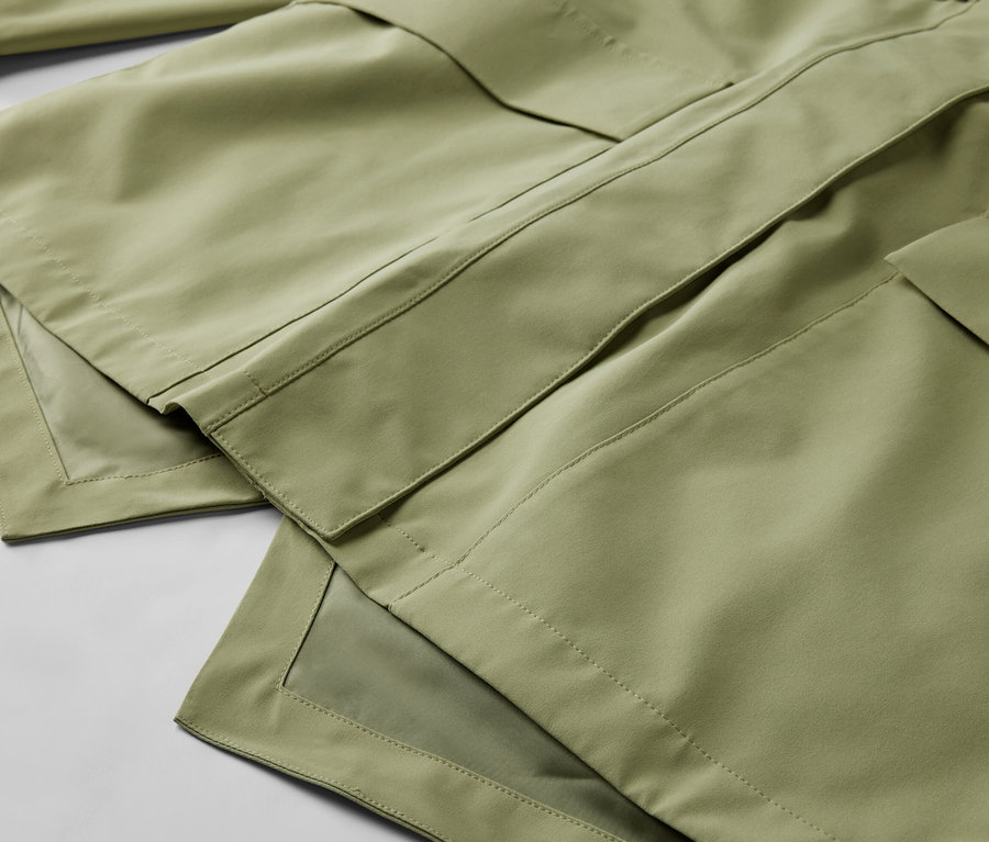 Detailaufnahme einer hellgrünen Regenjacke.