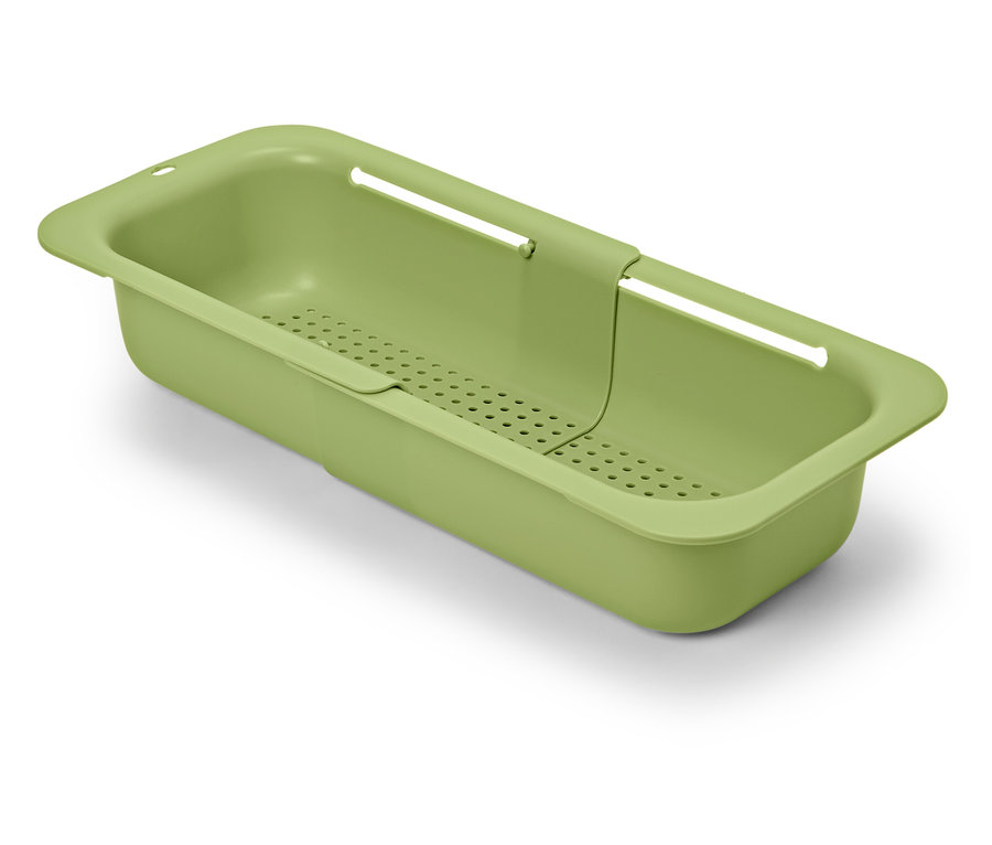 Grünes, ausziehbares Spülbeckensieb auf weißem Hintergrund.
