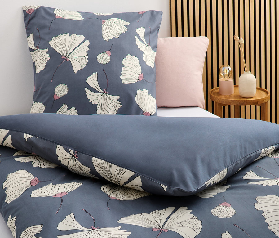 Nahaufnahme von dunkelblauer Microfaser-Bettwäsche mit Blumenmuster in Normalgröße und Übergröße.