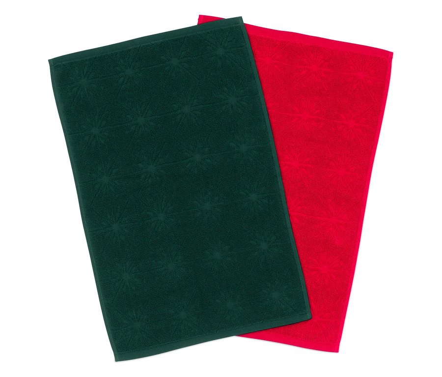 Zwei Handtücher: eines grün mit Sternchenmuster, das andere rot.