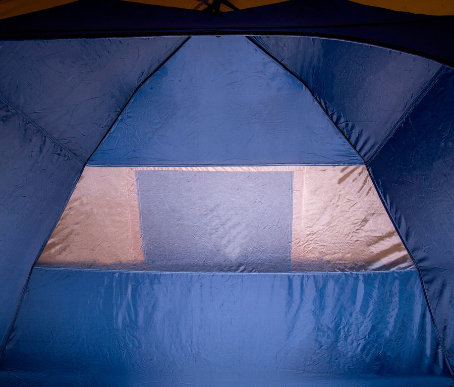 Innenansicht eines blauen Tambu 4-Personen-Kuppelzelts »SETU 4« mit rechteckigem Fenster.