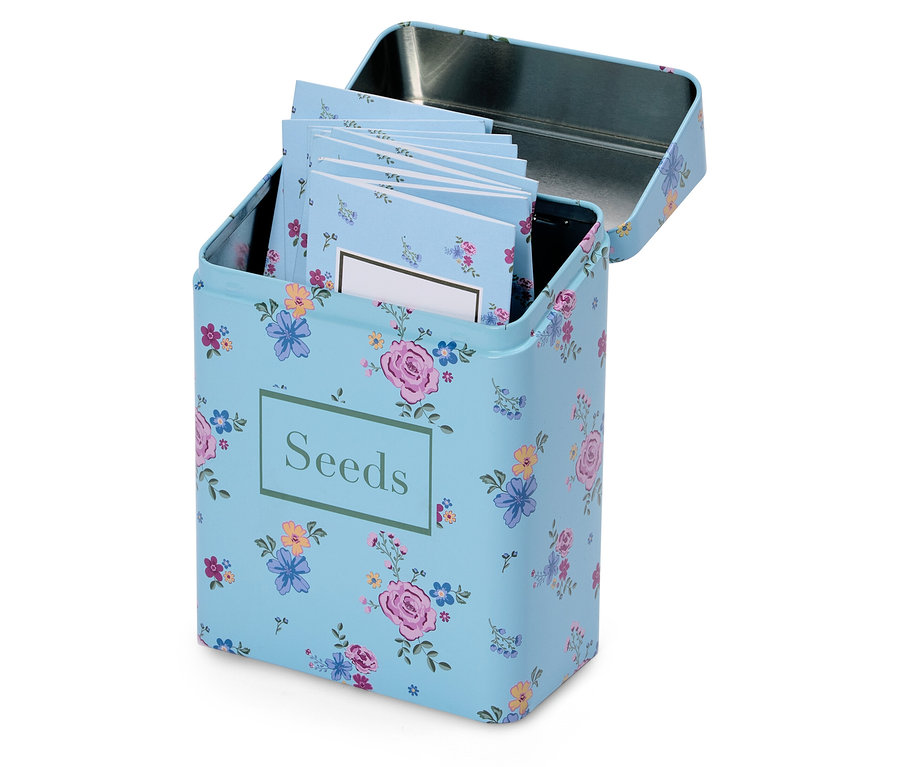 Eine geöffnete, hellblaue Blumensamenbox mit der Aufschrift "Seeds" und mehreren kleinen Notizblöcken darin.