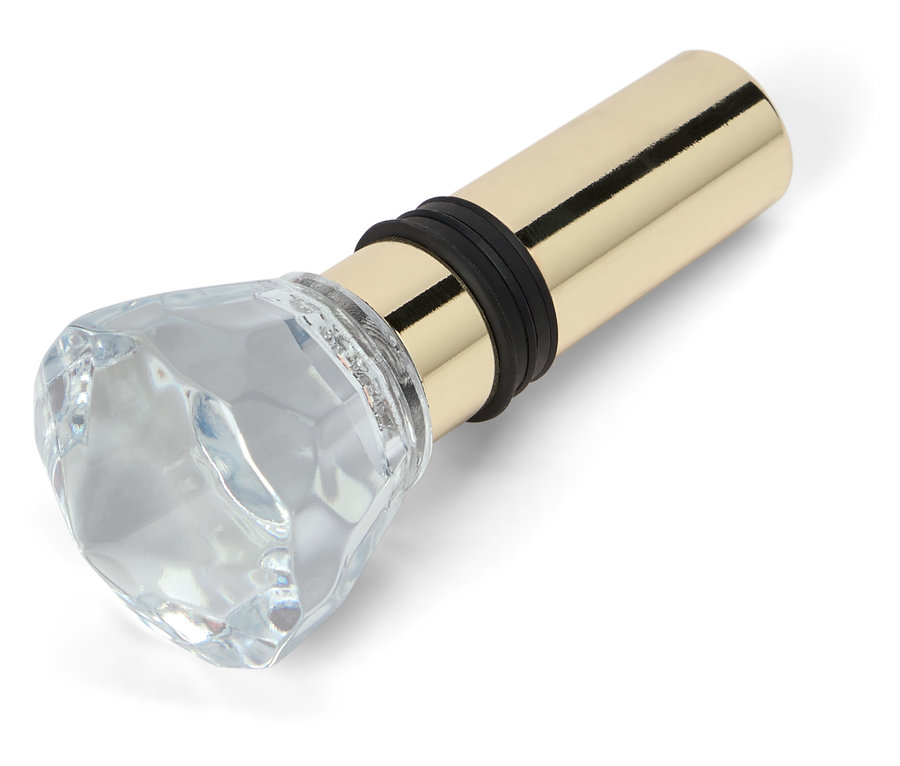 Flaschenverschluss mit rautenförmigem Glasaufsatz und goldenem Metallsockel.