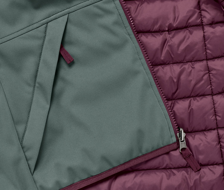 Detail einer 2-in-1-Kinder-Softshell-und-Steppjacke mit Reissverschluss und Tasche.