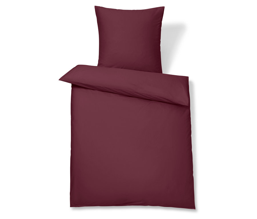 Weinrote Bettwäsche mit Kissenbezug.