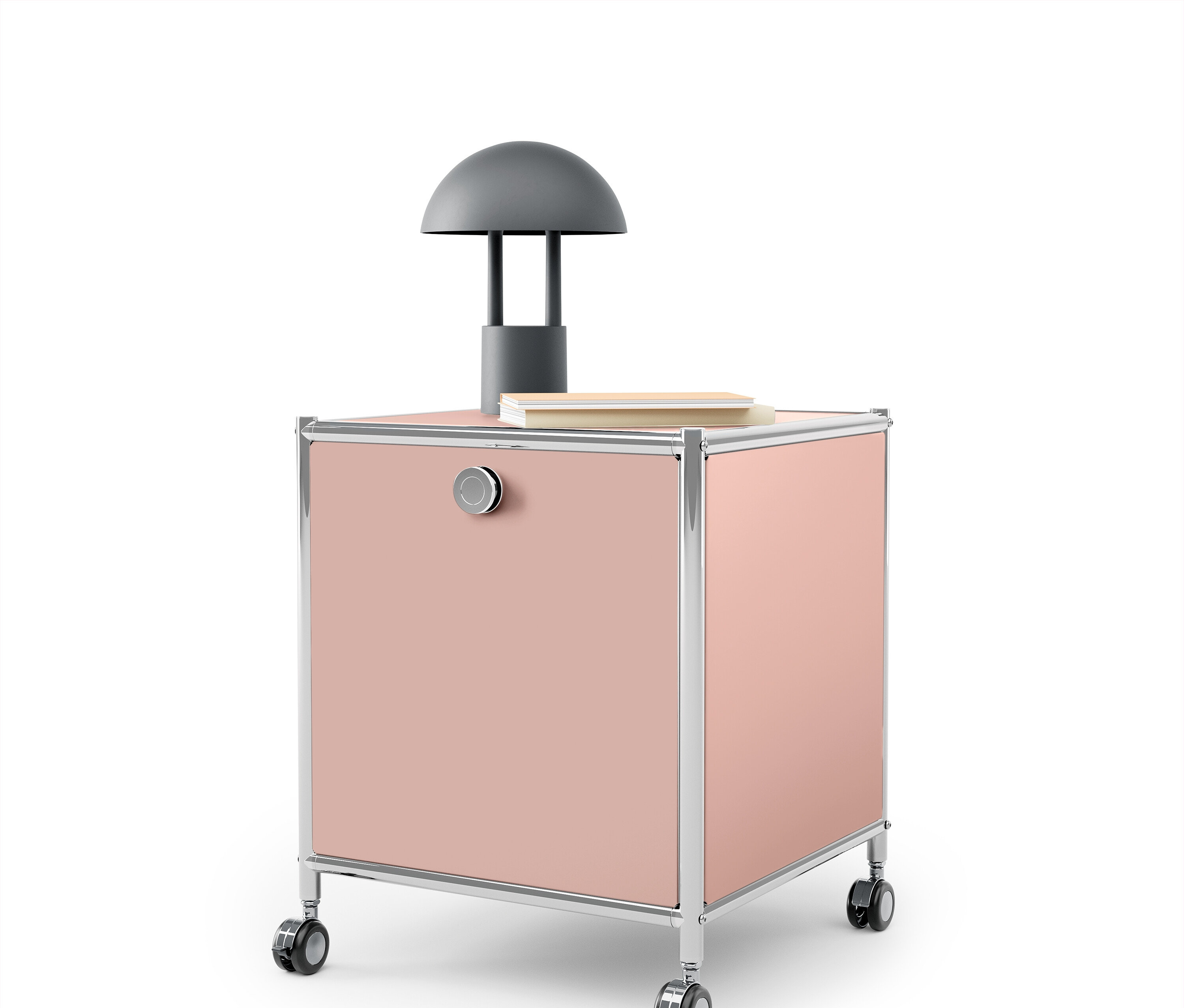 Rosa Rollcontainer mit Chromrahmen und grauer Lampe darauf.