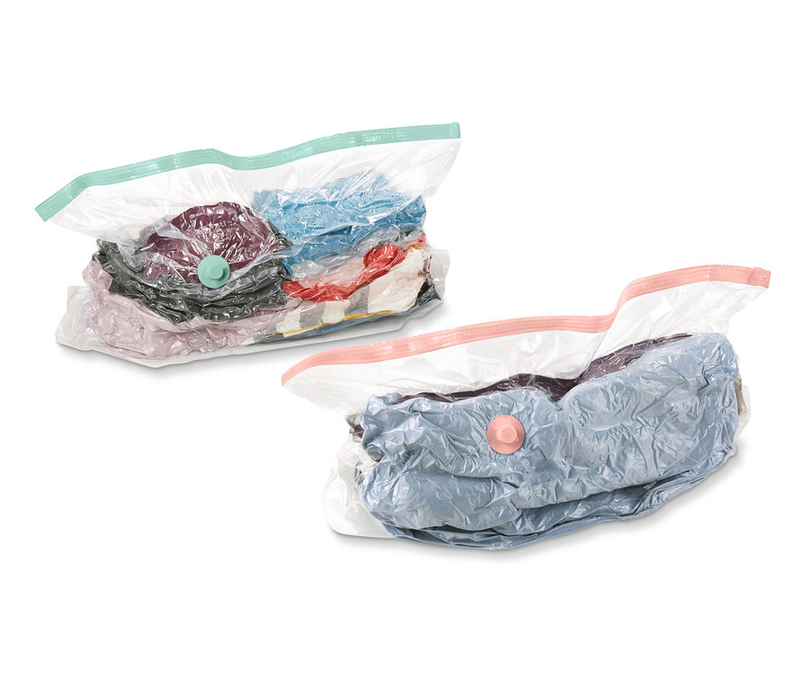 Zwei Vakuum-Aufbewahrungsbeutel, Würfel, gefüllt mit Kleidung, auf weißem Hintergrund.