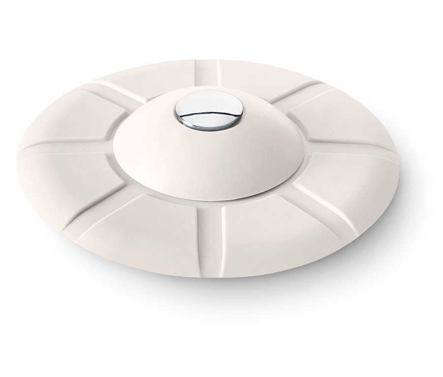 Cremefarbener, runder Gegenstand mit konvexem Oberteil und silbernem Knopf in der Mitte.