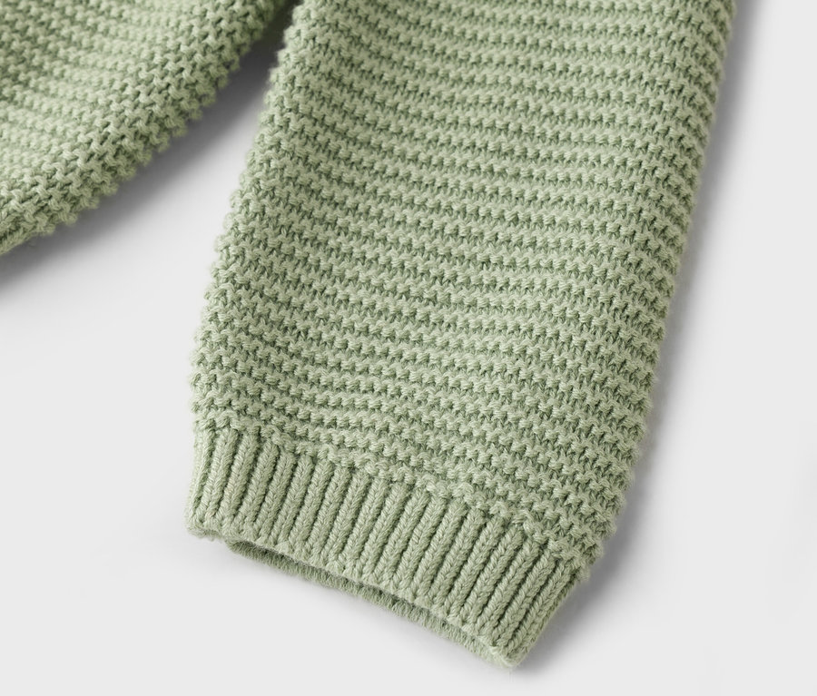 Nahaufnahme von hellgrünem Strickstoff